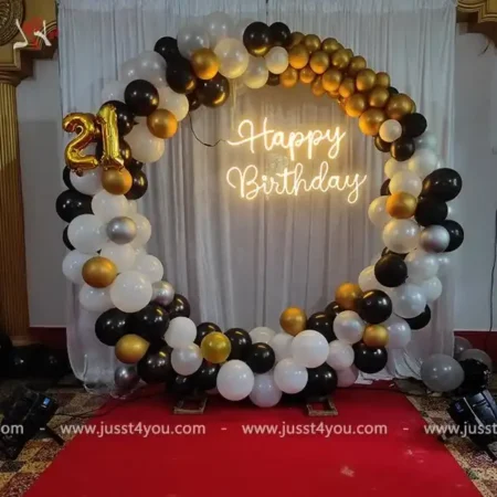 Oval backdrop with 32 inch foil balloons and HBD neon