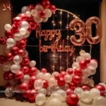 Oval backdrop with 32 inch foil balloons and HBD neon
