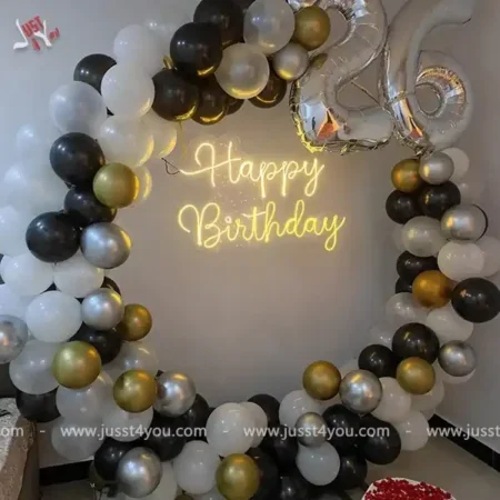 Oval backdrop with 32 inch foil balloons and HBD neon